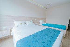 Postel nebo postele na pokoji v ubytování HOTEL VERANO