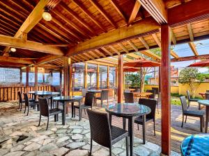 acovered patio with tables and chairs and tables and tablesearcher at Yukai Resort Premium Hotel Fugetsu in Beppu