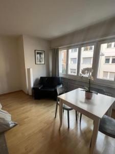 a living room with a table and a couch at Schweiz (302) in Basel