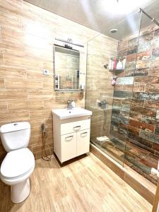 a bathroom with a toilet and a shower at The cozy corner in Yerevan