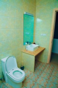 a bathroom with a toilet and a sink at Saint Emmanuel near Kigali Convetion center in Bugesera