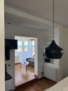 a living room with a black pendant light at ISOLA ROVI in Santo Spirito