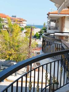 a balcony of a building with a view of the beach at Roula apartment in Nei Poroi