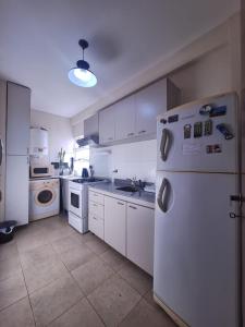 a kitchen with white appliances and a white refrigerator at Altos Resistencia in Resistencia