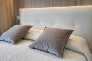 a bed with two pillows on top of it at Appartamento Centro storico - Massa in Massa