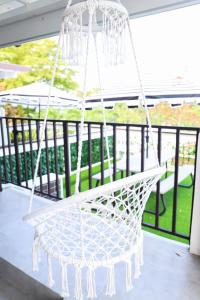 a white hammock hanging from a porch at Private Rooms in Duplex Home 4 Bath FQ Beds 1-3ppl in San Juan