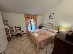 a bedroom with a large bed and a window at Vacanze Versilia in Viareggio