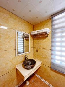 a bathroom with a sink and a mirror at Yijingju Humanistic Inn in Zhangjiajie +68 photos