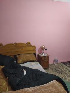 een slaapkamer met een bed en een tafel met een lamp bij Dar Dyafa 