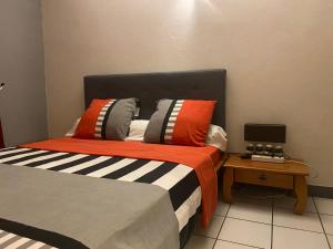 a bedroom with a bed and a table with a laptop at Happyhome in Saint-Pierre