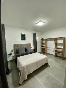 a bedroom with a large bed in a room at LES VILLAS PAMEYAQUE 2 F2 avec 1 piscine et 1 F3 avec 1 piscine, Superbe Vue sur la mer in Rivière-Salée