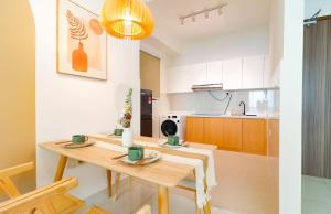 a kitchen with a wooden table in a room at Greenfield Residence At Sunway City by Nexx Field in Petaling Jaya