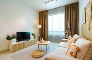 a living room with a couch and a tv at Greenfield Residence At Sunway City by Nexx Field in Petaling Jaya