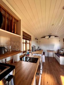a kitchen with wooden floors and a counter top at Woodpecker Hill - apple orchard in Alfriston in Alfriston