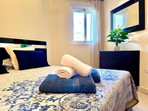 een slaapkamer met een bed met een handdoek erop bij Spacious, comfortable and close to the beach in Torre del Mar +23 foto's
