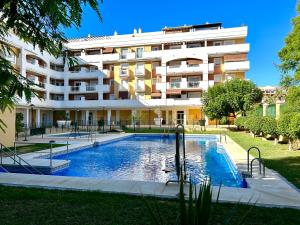 een gebouw met een zwembad voor een gebouw bij Spacious, comfortable and close to the beach in Torre del Mar