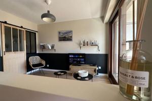 a bottle of wine sitting on a counter in a living room at Destination Léman in Thonon-les-Bains