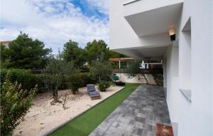 a house with a patio with a lawn at Cld688, Villa Vlahov I in Šibenik
