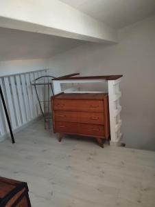 a wooden dresser in a room with a wall at Studio en Petite Camargue in Le Cailar