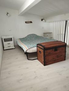 a bedroom with a bed with a wooden trunk in it at Studio en Petite Camargue in Le Cailar