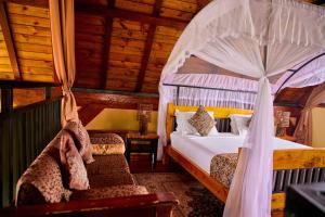 a bedroom with a bed with a canopy at Shamba lodge in Arusha