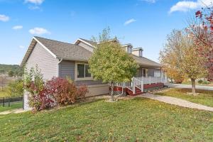 a house with a yard with trees in front of it at Modern Home-Garage-Scenic Patio in Rapid City