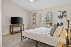 a bedroom with a bed and a flat screen tv at Modern Home-Garage-Scenic Patio in Rapid City