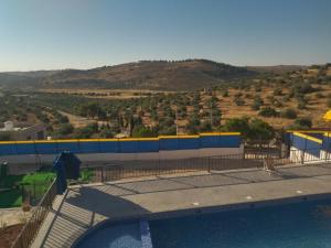 a building with a pool of water and a mountain at شاليه 