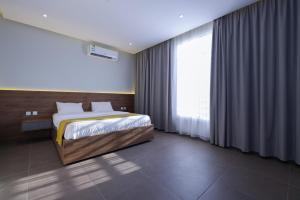 a bedroom with a bed and a large window at شقق المبات للشقق المخدومة in Riyadh +30 photos