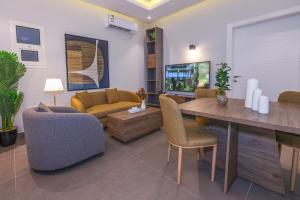 a living room with a couch and a table and chairs at شقق المبات للشقق المخدومة in Riyadh