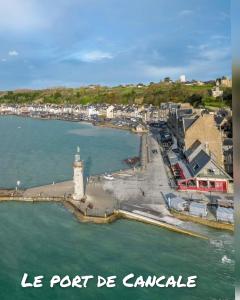 a view of a harbor with a lighthouse in the water at Le p’tit tram in Cancale