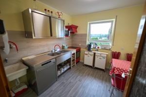 a small kitchen with a sink and a table at Limburger MiKa -Whg3Zimmer P&Wallbox Garten in Limburg an der Lahn