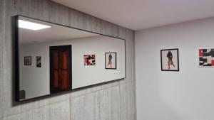 a mirror on a wall with pictures on it at Underground SINTRA experiencia in Almansa