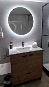 a bathroom with a sink and a mirror at Underground SINTRA experiencia in Almansa