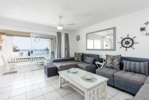 a living room with a couch and a table at Laguna La Crete 106 in Uvongo Beach