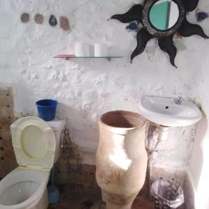 a bathroom with a toilet and a sink at Fertassa mtls in Moulay Idriss