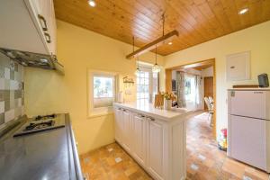 a kitchen with a refrigerator and a counter top at 宜蘭暖暖屋2-9人包棟民宿-1次只接1組客人 in Renhe