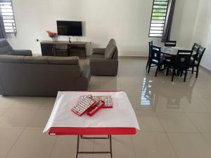 a living room with a couch and a table at homestay port dickson - elaine in Port Dickson