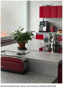 a kitchen with a red appliance on a counter at Zimmer Orange mit Weitblick und Sauna in Sundern
