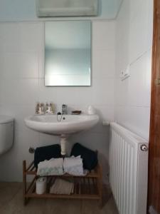 a bathroom with a sink and a mirror at Pagés in Sant Climent Sescebes