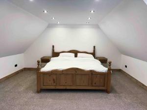 a bedroom with a large bed in a attic at The Stables at Historic Grade ll Listed Farm in Broadstairs