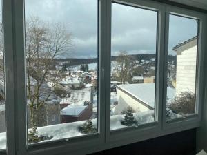 a view of a snowy city from a window at Ferienwohnung Felix Braunlage in Braunlage