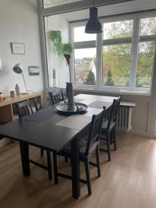 a dining room table and chairs with a vase on it at Ferienwohnung Felix Braunlage in Braunlage