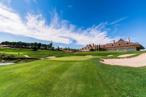 a golf course with a house in the background at Spectacular villa with pool in Madrid and privacy in Madrid