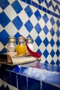 two glass jars of honey on a tray on a counter at Riad Tizwa Fes in Fez