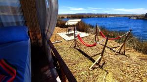 a tent with a view of a body of water at TITICACA JALTAWI LODGE in Puno