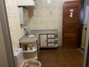een kleine badkamer met een wastafel en een toilet bij Casa ampla de frente ao mar in Cacha Pregos