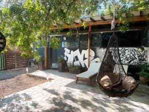 a hammock and a bench in front of a building at - Magic Bus - in Chlorakas