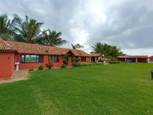 a house with a large lawn in front of it at Shilpgram in Bhuj
