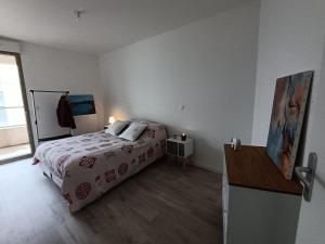 Chambre dans un joli appartement cosy في بوردو: غرفة نوم بسرير ومكتب ونافذة